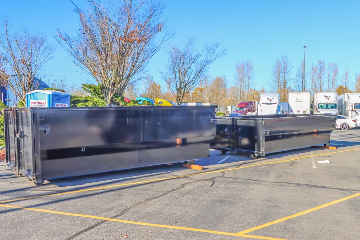 Professional dumpster rental service with roll-off container on residential driveway in Brooksville